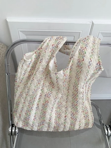 Close-up of vibrant neon rainbow knit tote bag with 3D floral mesh texture