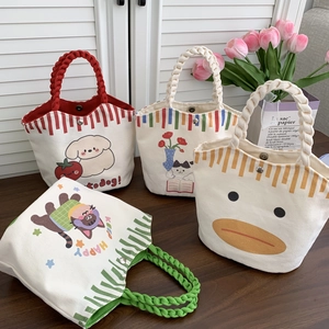 Detail of four cute canvas bucket bags with woven rope handles and cartoon animal prints