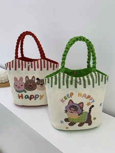 Detail of canvas tote bags with cartoon prints, woven rope handles, and metal button closure