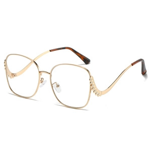 Oversized gold metal sunglasses with wavy rhinestone frames and tortoiseshell temples