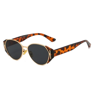 Vintage oval sunglasses with leopard print frames and golden metal details on white background