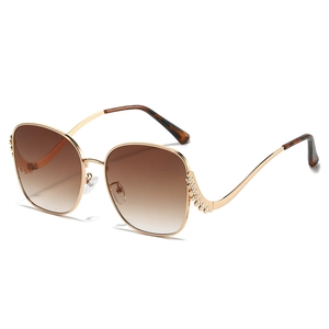 Oversized gold metal butterfly sunglasses with brown gradient lenses and rhinestone temples