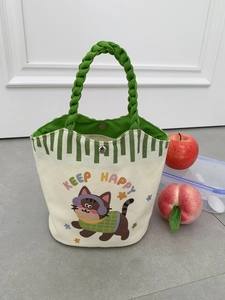 Detail of canvas tote bag with magnetic clasp and green woven handles for daily use