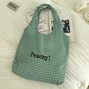 Green striped canvas tote bag with Peachy print shown with casual lifestyle accessories