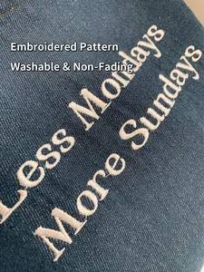 Blue denim tote bag with Less Mondays More Sundays white embroidery details
