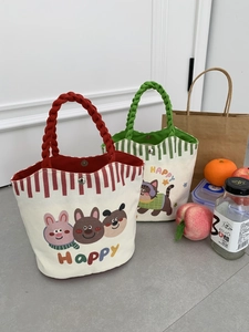 Detail of canvas tote bags with cartoon prints, rope handles and magnetic metal closures