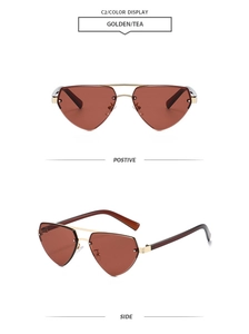 Close-up of golden metal rimless heart-shaped sunglasses with dark tea lenses