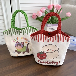 Detailed view of woven handles and cartoon cat and dog prints on canvas bucket bags