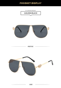 Detail of aviator sunglasses with gold frames and double heart-shaped hollow decoration