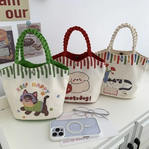 Detail of cartoon canvas bucket bags with rope handles and secure magnetic closure