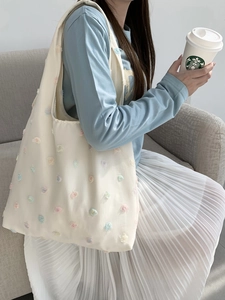 Beige canvas tote bag with 3D floral embroidery, ideal for daily commute or campus