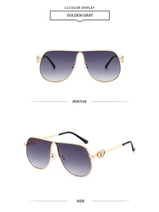 Detail of pilot sunglasses with golden frames and hollow heart hinge decoration
