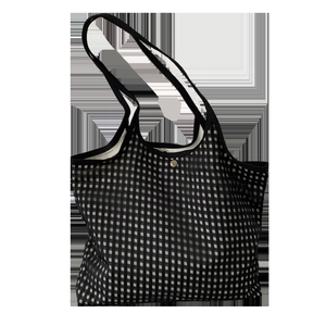 Top view detail of a checkered tote bag showing the metal snap button closure and lining