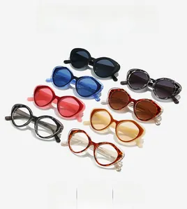 Flat lay of retro cat eye sunglasses in 8 color variants with thick acetate frames