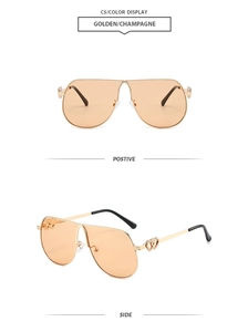 Detail of pilot sunglasses showing gold metal frame and unique heart temple decoration