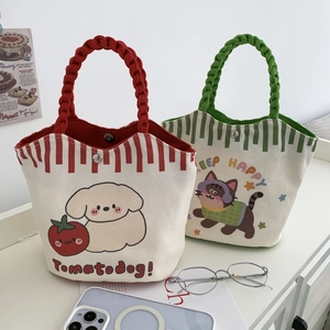 Close-up of canvas bucket bags with cartoon prints and magnetic snap closure detail
