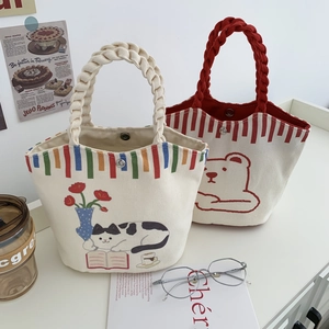Detail of cute canvas bucket bags with magnetic snap closure and woven handles