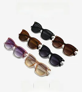 Flat lay of square sunglasses in multiple colors including tortoiseshell and gradients