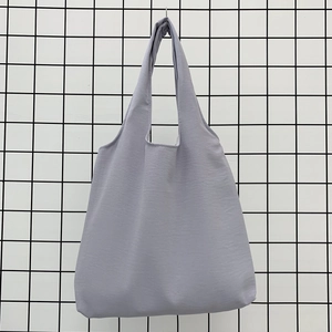 Detail shot of light purple canvas tote bag texture with minimalist seamless handles