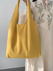 Close-up of ginger yellow canvas tote bag with wide straps for everyday commute