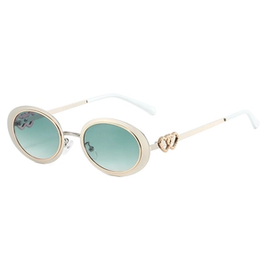 Fashionable oval metal sunglasses for women with golden frames and gradient green lenses