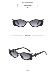 Nahaufnahme der Sonnenbrille in Fledermausform mit schwarzem Rahmen und grauen Gläsern