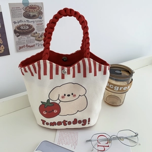 Close-up of the cartoon canvas bucket bag featuring red woven ropes and a magnetic buckle