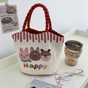 Canvas bucket bag with cartoon animals and red woven handles on white background