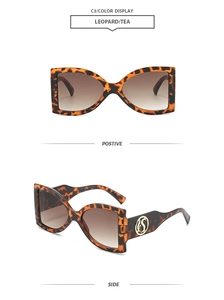 Detail view of leopard print rectangular sunglasses with gold S-logo and tea lenses