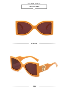 Detail view of oversized orange frame sunglasses with red lenses and gold logo