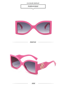 Detail view of pink butterfly sunglasses showing the side gold logo and front design