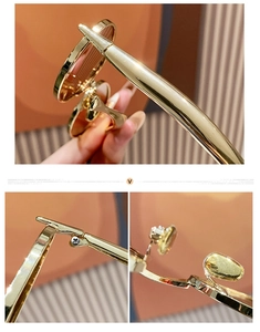 Detail of golden oval metal sunglasses frame with streamlined temples and precision hinges
