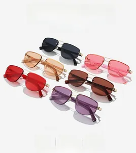 Close-up of rimless polygon sunglasses with metal double bridge in multiple lens colors