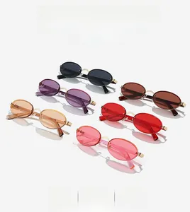 Flat lay of oval rimless sunglasses in multiple colors with sleek gold metal temples
