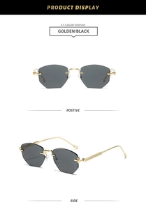 Detail of rimless polygon sunglasses with golden metal temples and dark grey lenses