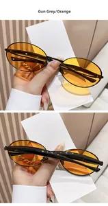 Detail view of oval gunmetal frame sunglasses with translucent orange lenses A371