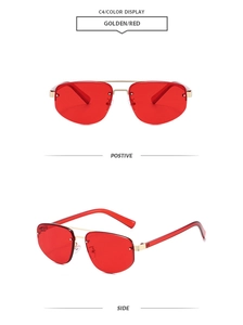 Detail view of rimless red polygon sunglasses with golden metal bridge and temples