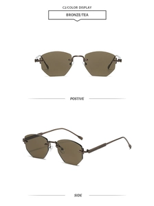 Detail of rimless hexagonal sunglasses with bronze metal temples and tea-tinted lenses