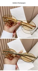 Detailed view of oval golden metal sunglasses with champagne tinted lenses for women