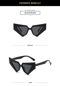 Macro detail of black geometric avant-garde sunglasses showing sharp frame edges and texture