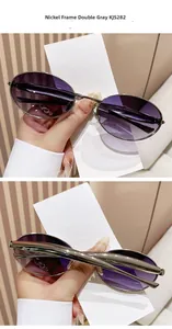 Detail view of oval metal sunglasses KJS282 with nickel frame and gradient grey lenses