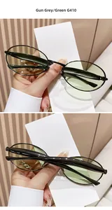 Detail of oval gunmetal sunglasses with green lenses and slim metal frame model G410