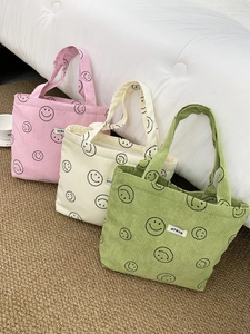 Detailed corduroy tote bags with smiley patterns in pink, white, and green colors