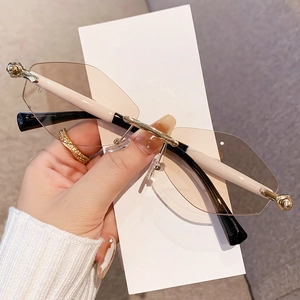 Lunettes de soleil géométriques sans monture avec verres marron dégradé et pont doré