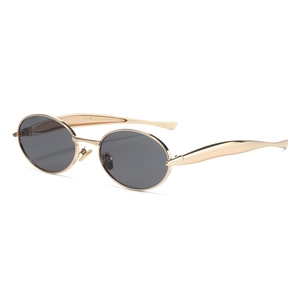 Modern oval metal sunglasses with golden frame and dark lenses at a 45-degree angle view