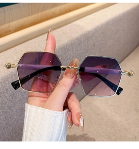 Detailed view of golden metal sunglasses frame featuring elegant rhinestone temple accents
