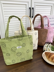 Corduroy tote bags with smiley face patterns in green, white, brown and pink colors
