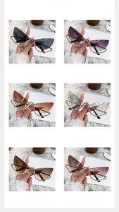 Détail de lunettes de soleil œil-de-chat sans monture avec branches chaînettes en strass