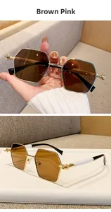Detail of square gold metal sunglasses with brown pink lenses and bicolor temples