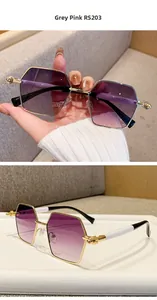 Detailed macro view of gold hexagonal frame sunglasses with grey pink gradient lenses